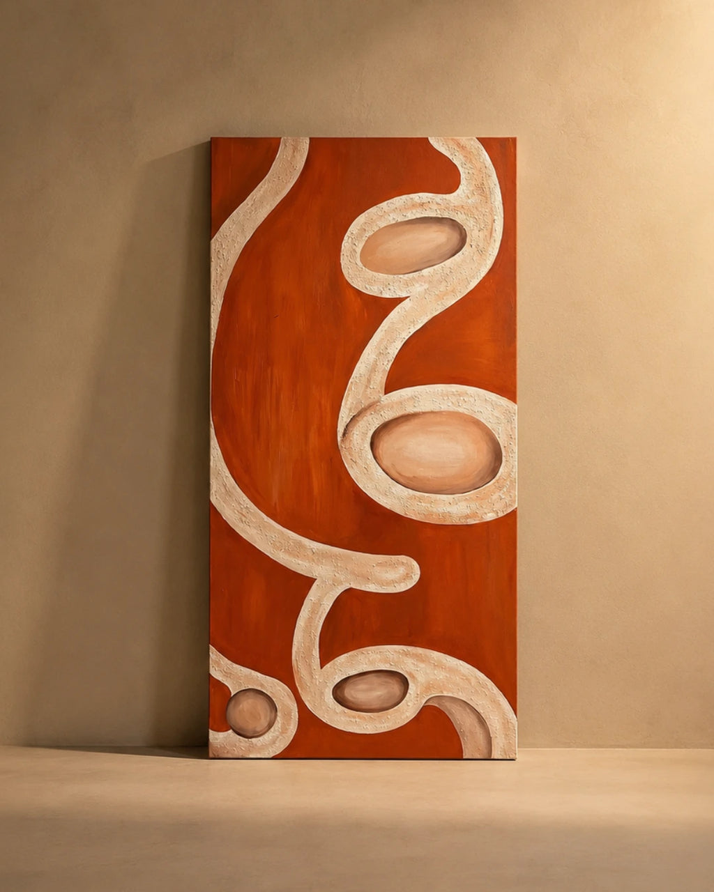 An abstract vertical canvas painting with flowing organic shapes in terracotta orange and cream, displayed leaning against a textured beige wall on a matching floor.