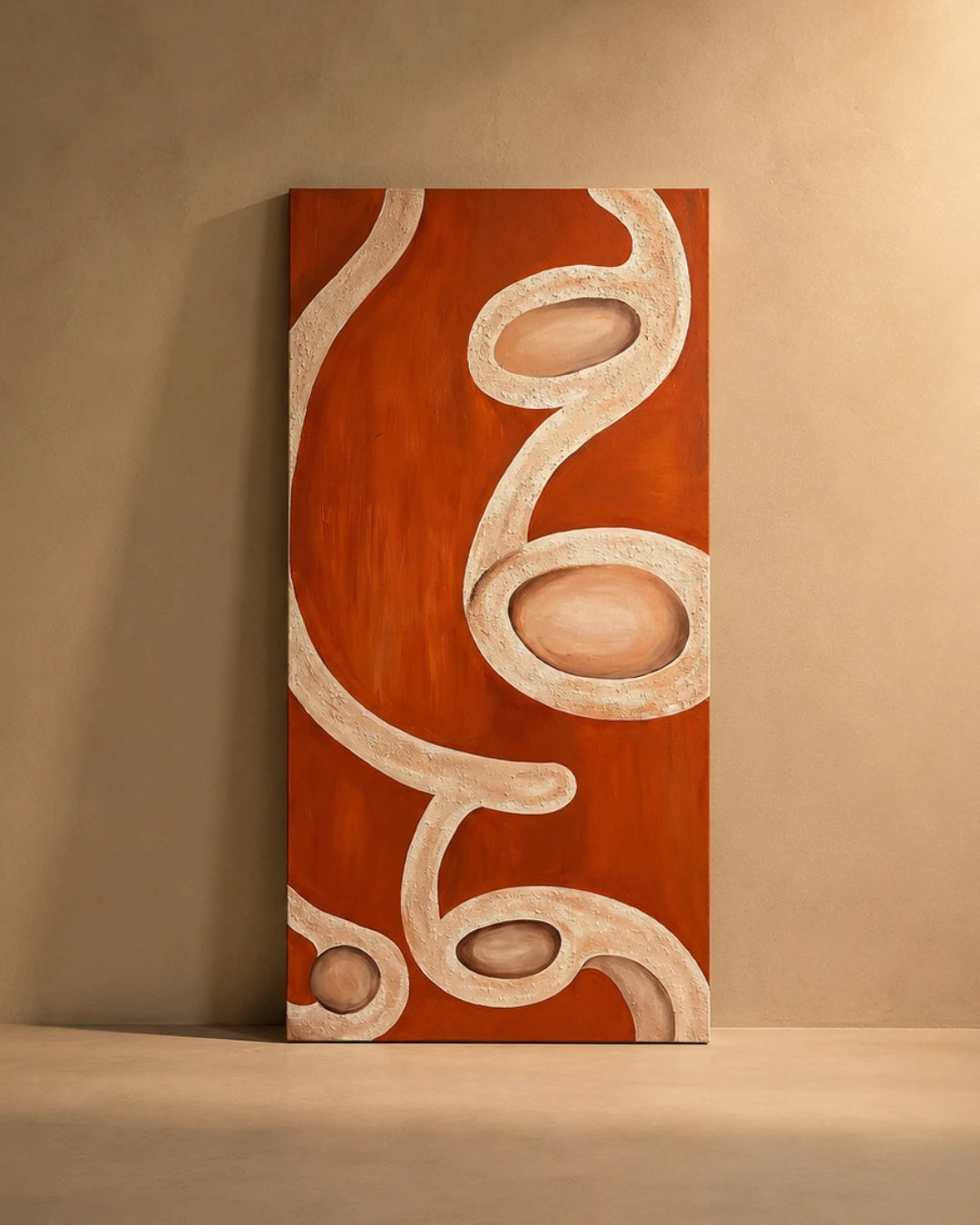 An abstract vertical canvas painting with flowing organic shapes in terracotta orange and cream, displayed leaning against a textured beige wall on a matching floor.