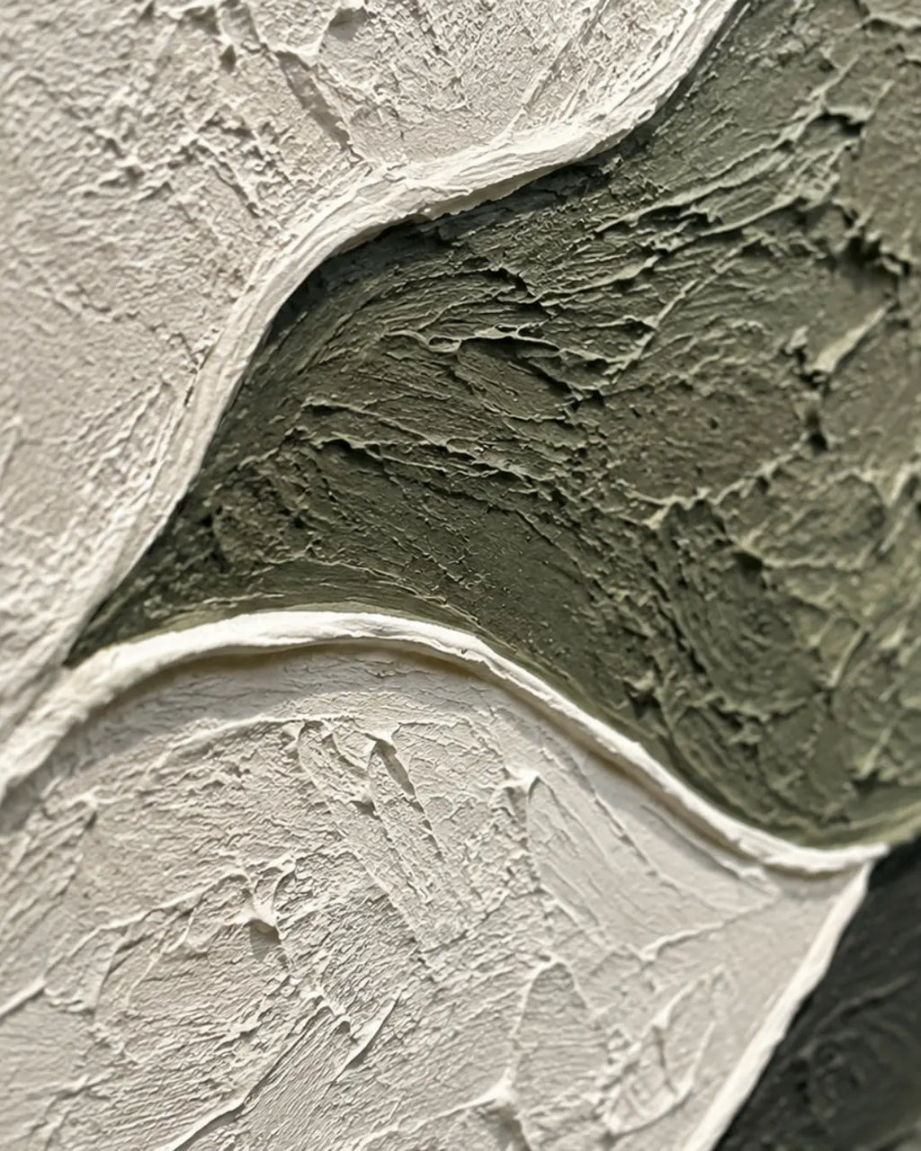 Abstract textured wall art featuring thick, impasto brushstrokes in off-white, muted olive green, and a small dark gray section.