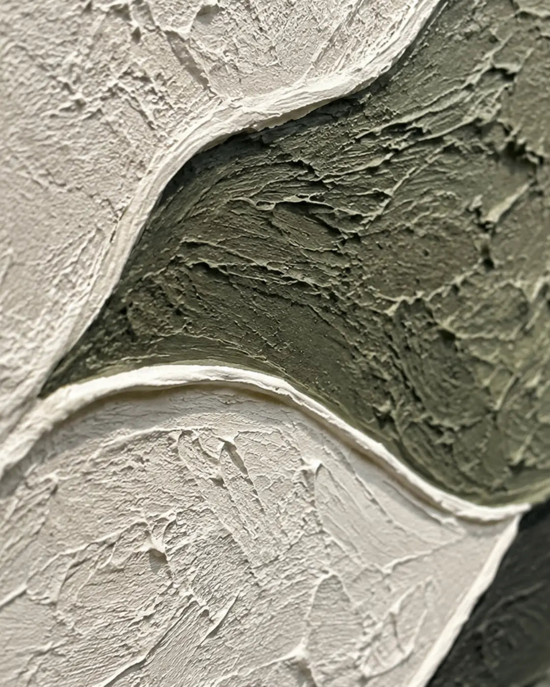 Abstract textured wall art featuring thick, impasto brushstrokes in off-white, muted olive green, and a small dark gray section.
