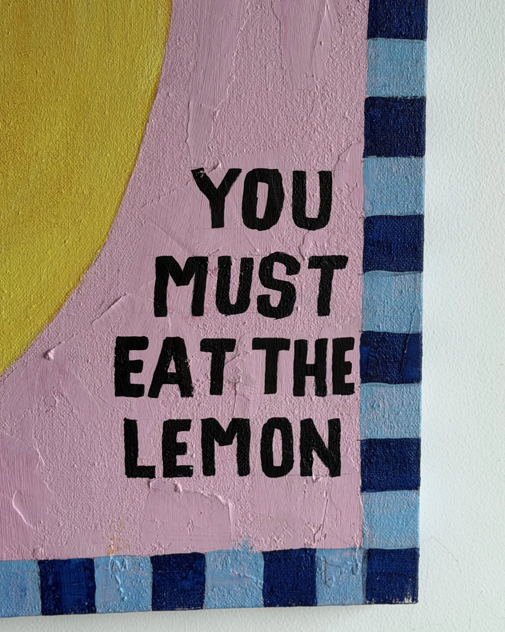 Text 'YOU MUST EAT THE LEMON' on a colorful abstract background