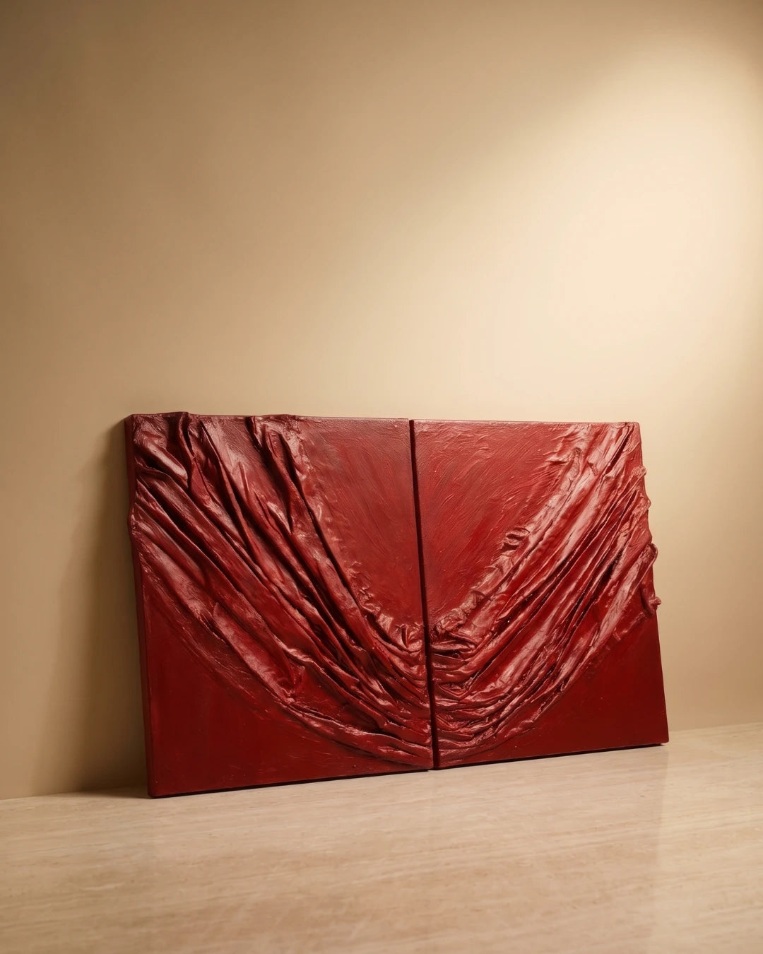 Red fabric sculpture on a beige wall