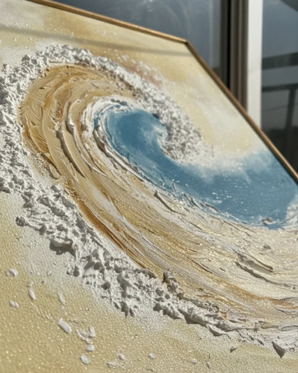 Framed artwork resembling a natural landscape with sand and water.