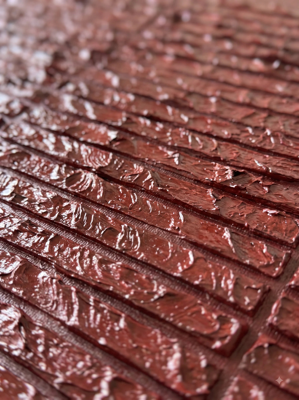 Close-up of Brickwork canvas showing hand-carved deep red ridged texture