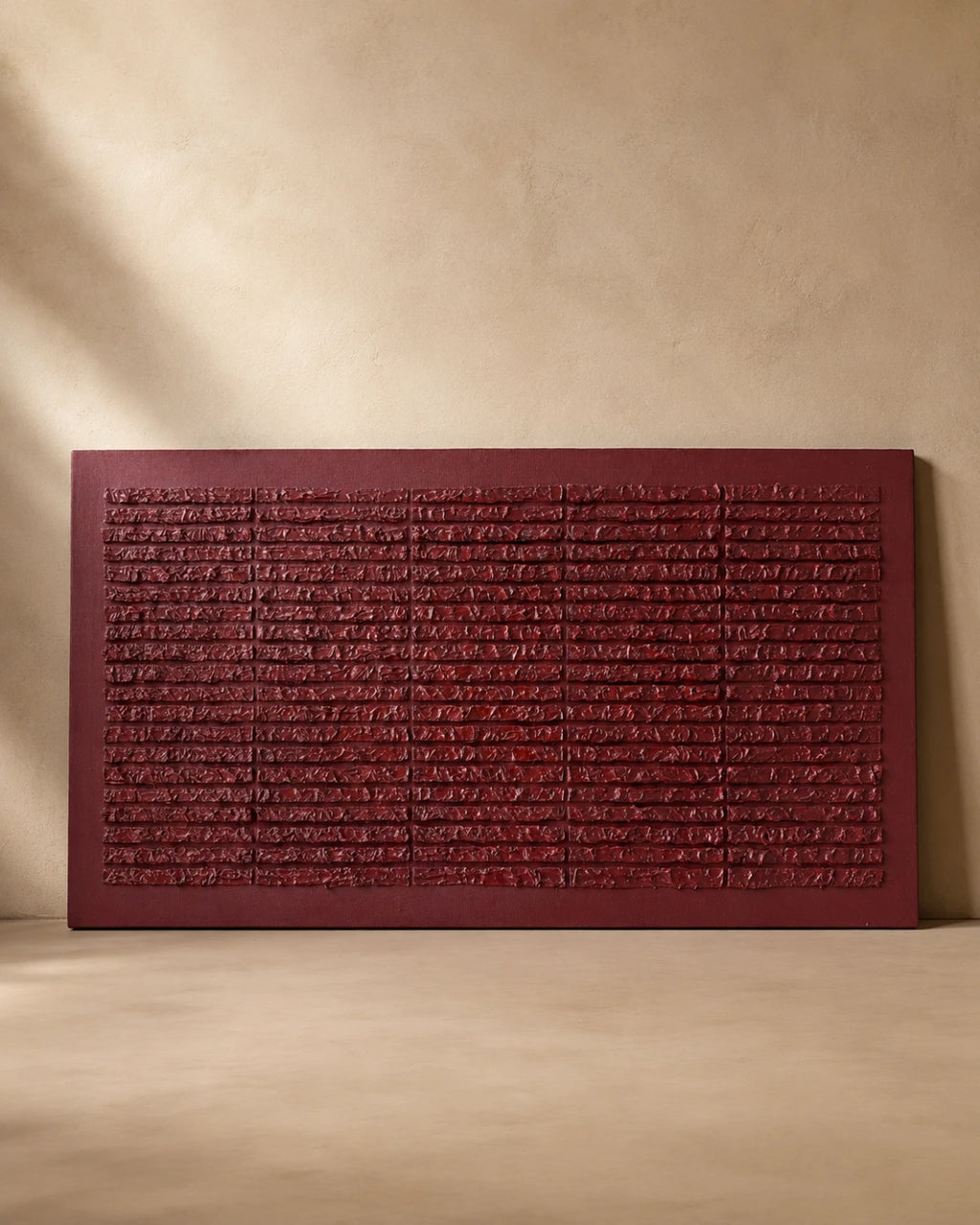 Deep red textured wall art with hand-carved horizontal ridges on plain background, handmade canvas painting