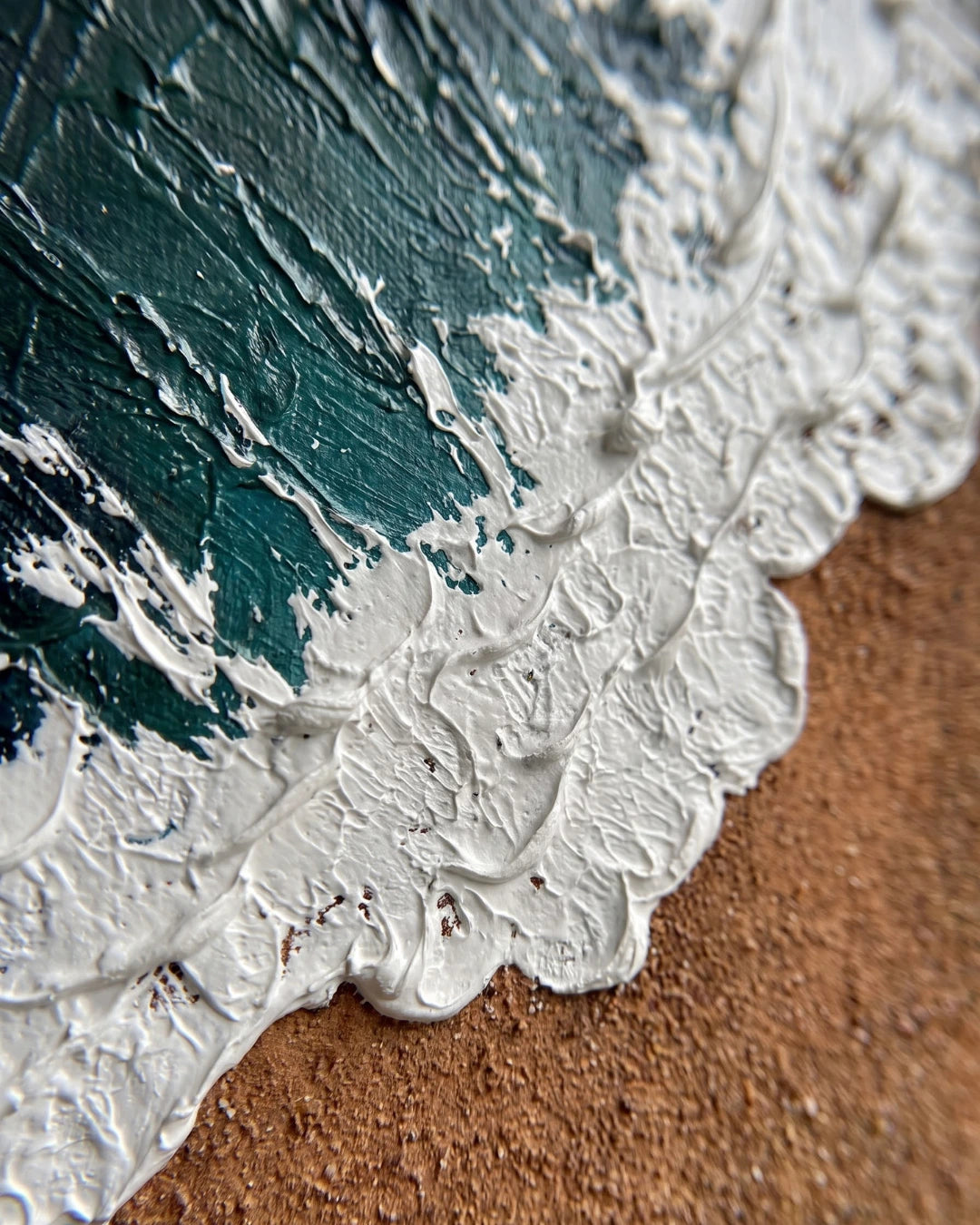 Close-up of raised white foam texture on Coastal Calm canvas showing hand-built sand and paint layers