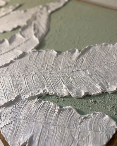 Close-up of raised white plaster fern frond on Fern Row canvas showing hand-carved veining