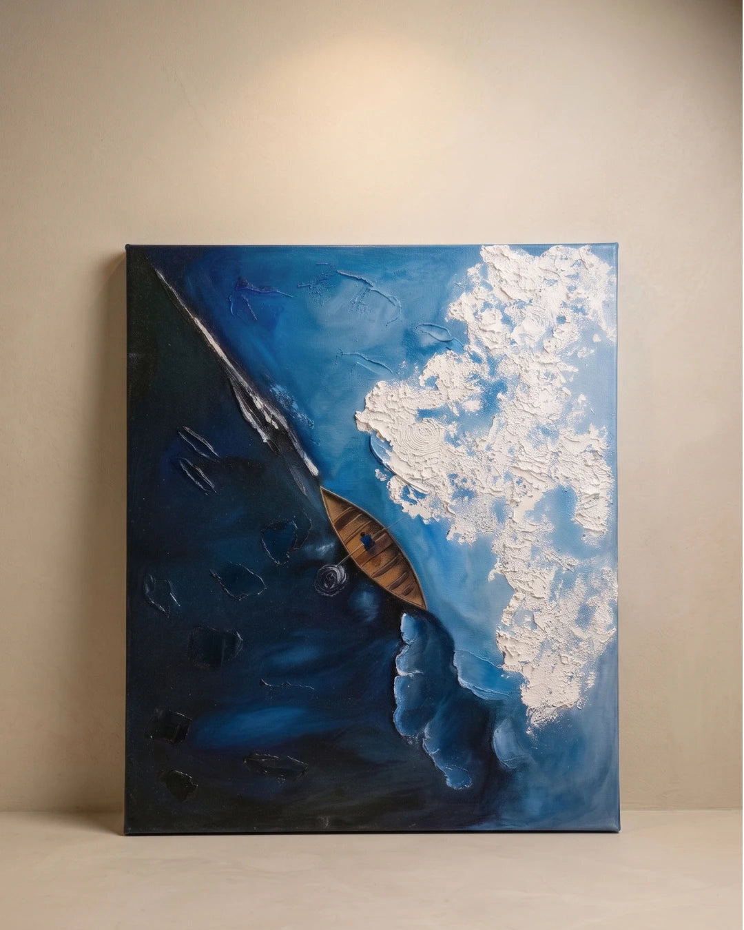 Aerial textured painting of a wooden kayak on deep blue ocean with raised white foam wave, handmade canvas wall art
