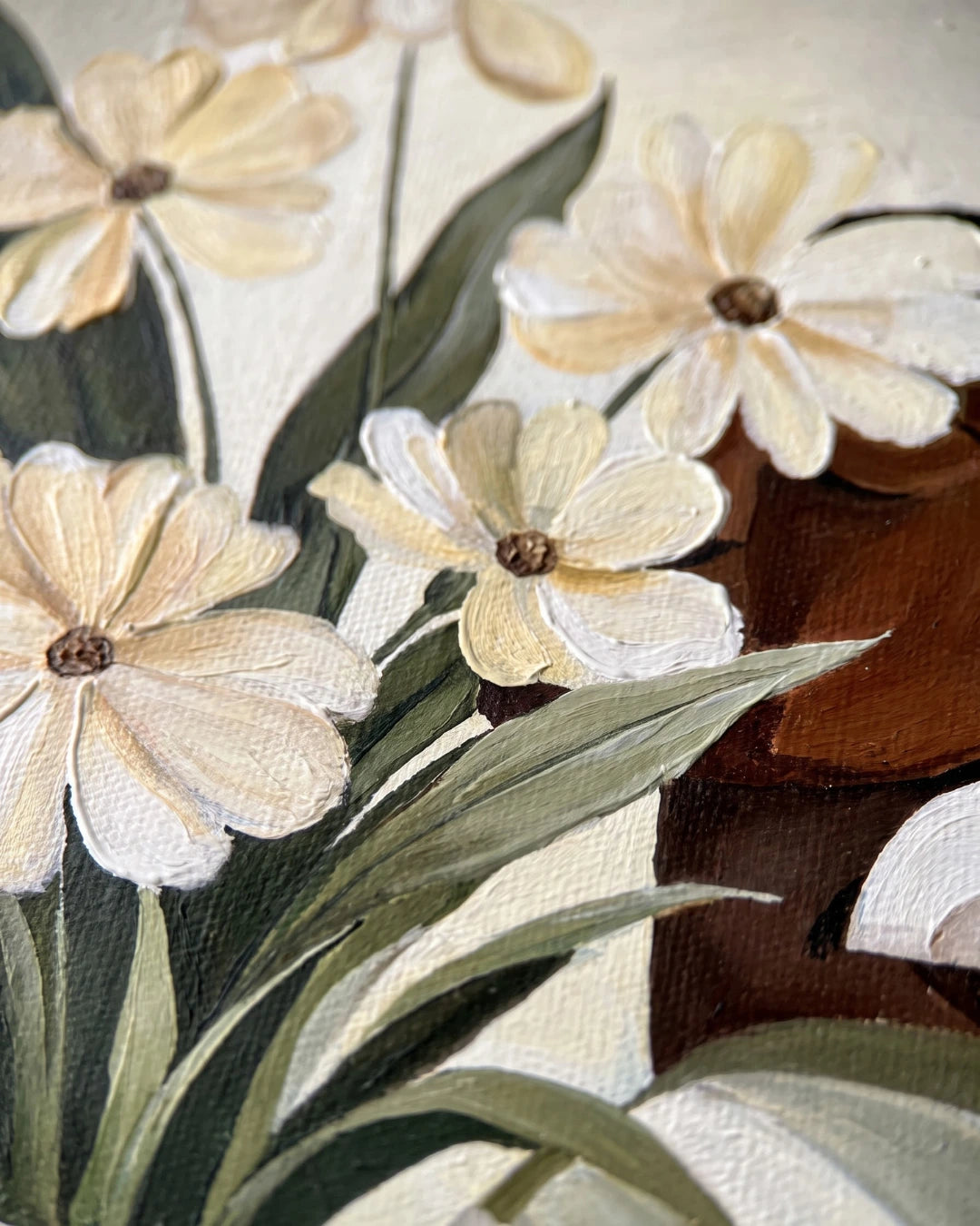 Close-up of cream flowers and green leaves on Petals & Her canvas showing hand-painted detail