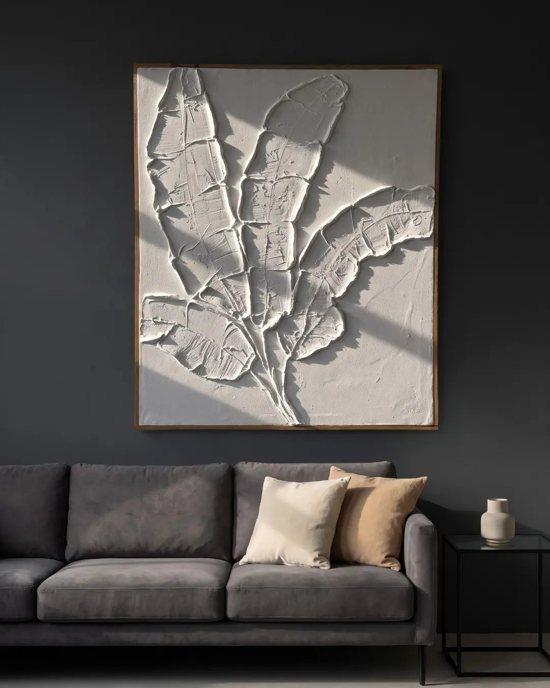 Quiet Banana Leaf white textured painting hanging above a sofa in a modern Indian living room