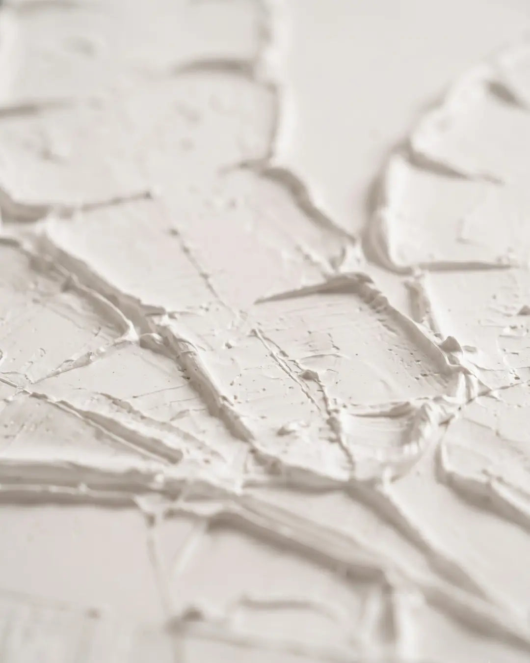 Close-up of raised white plaster on Quiet Banana Leaf canvas showing carved leaf spine and split edges