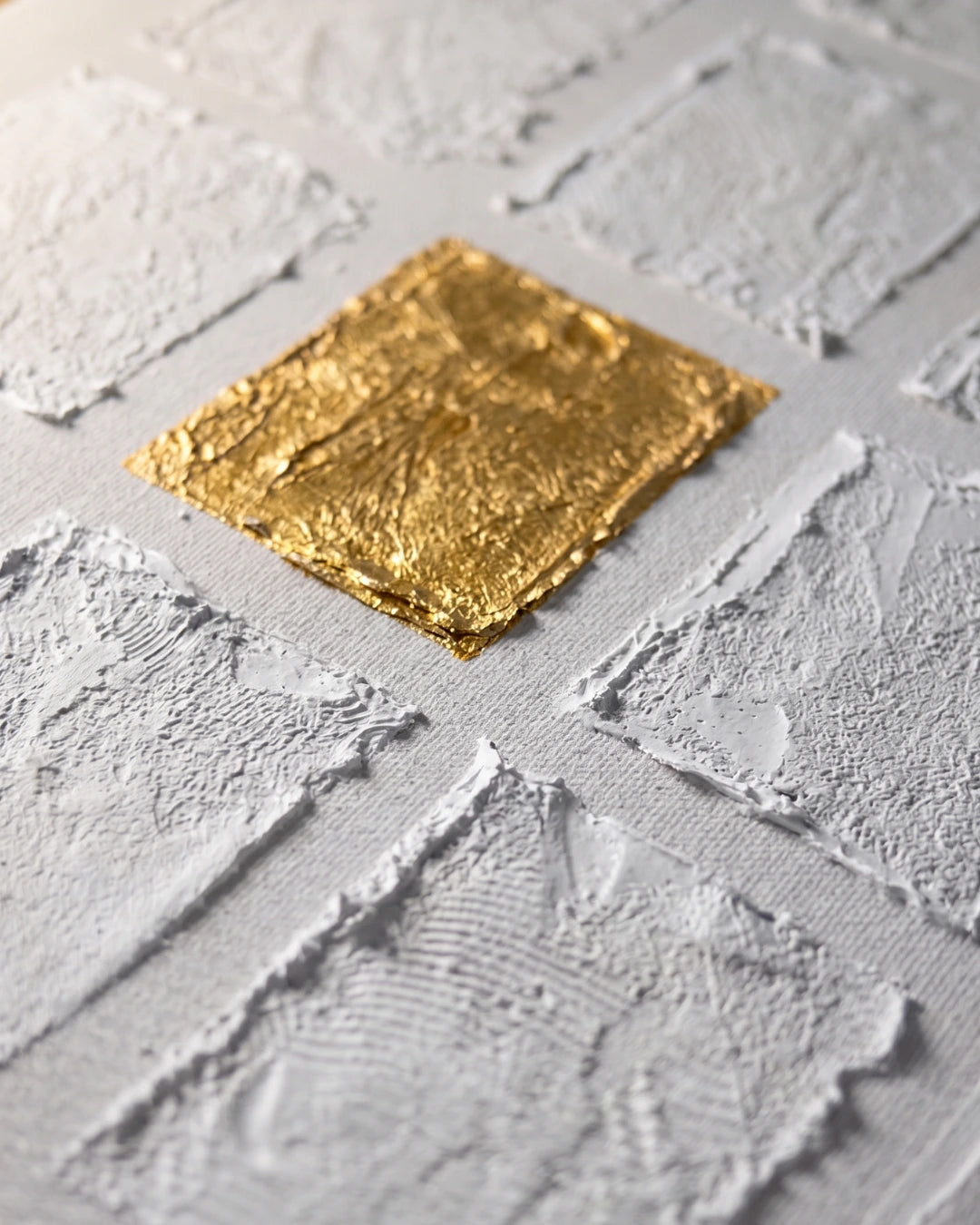 Close-up of the gold leaf square on Rare canvas showing hand-applied metallic texture