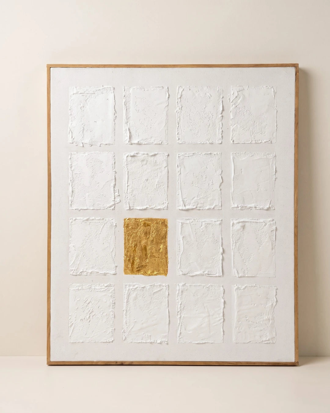 White textured wall art 27x32 inches with sixteen hand-built tiles in a grid and one gold leaf square, handmade canvas painting
