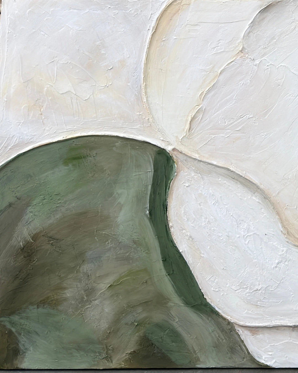 Close-up of organic ivory and green shapes on Riverbed canvas showing hand-textured plaster