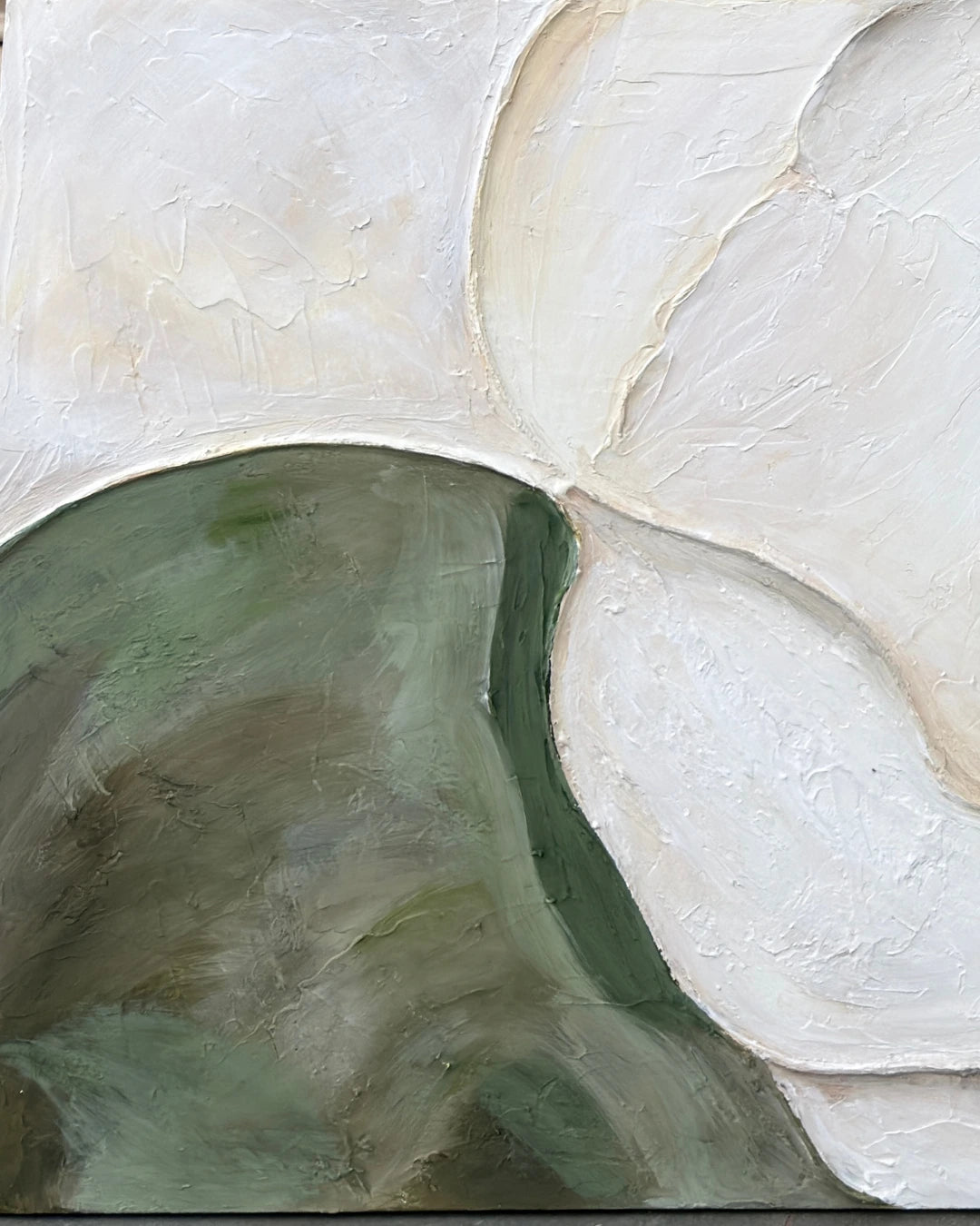 Close-up of organic ivory and green shapes on Riverbed canvas showing hand-textured plaster