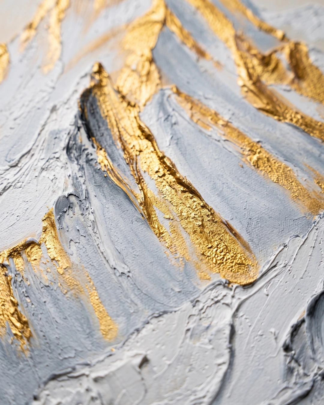 Close-up of gold leaf and raised white texture on Summit Gold canvas showing hand-built mountain ridges