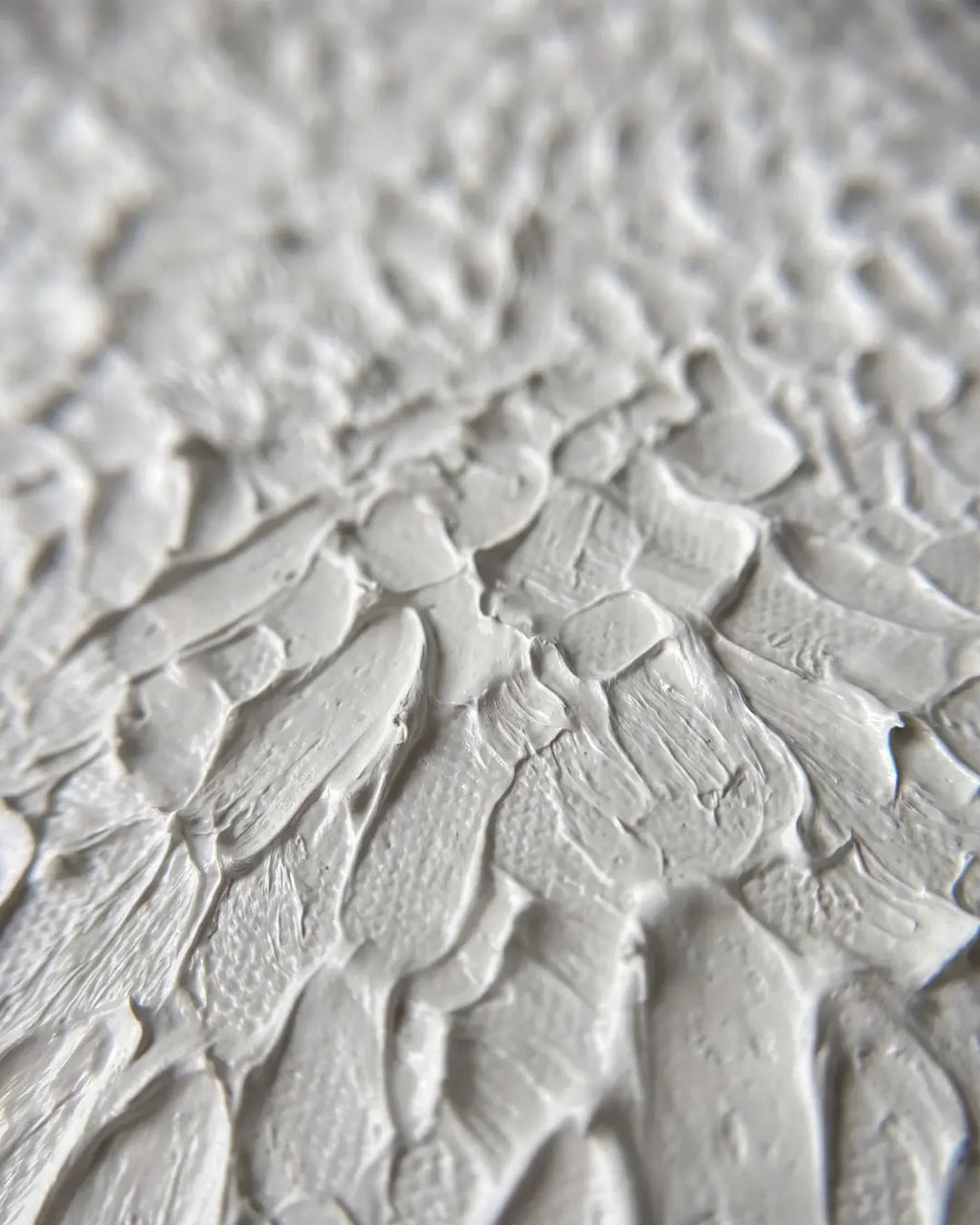 Close-up of The White Relief canvas showing dense hand-carved crackled plaster texture