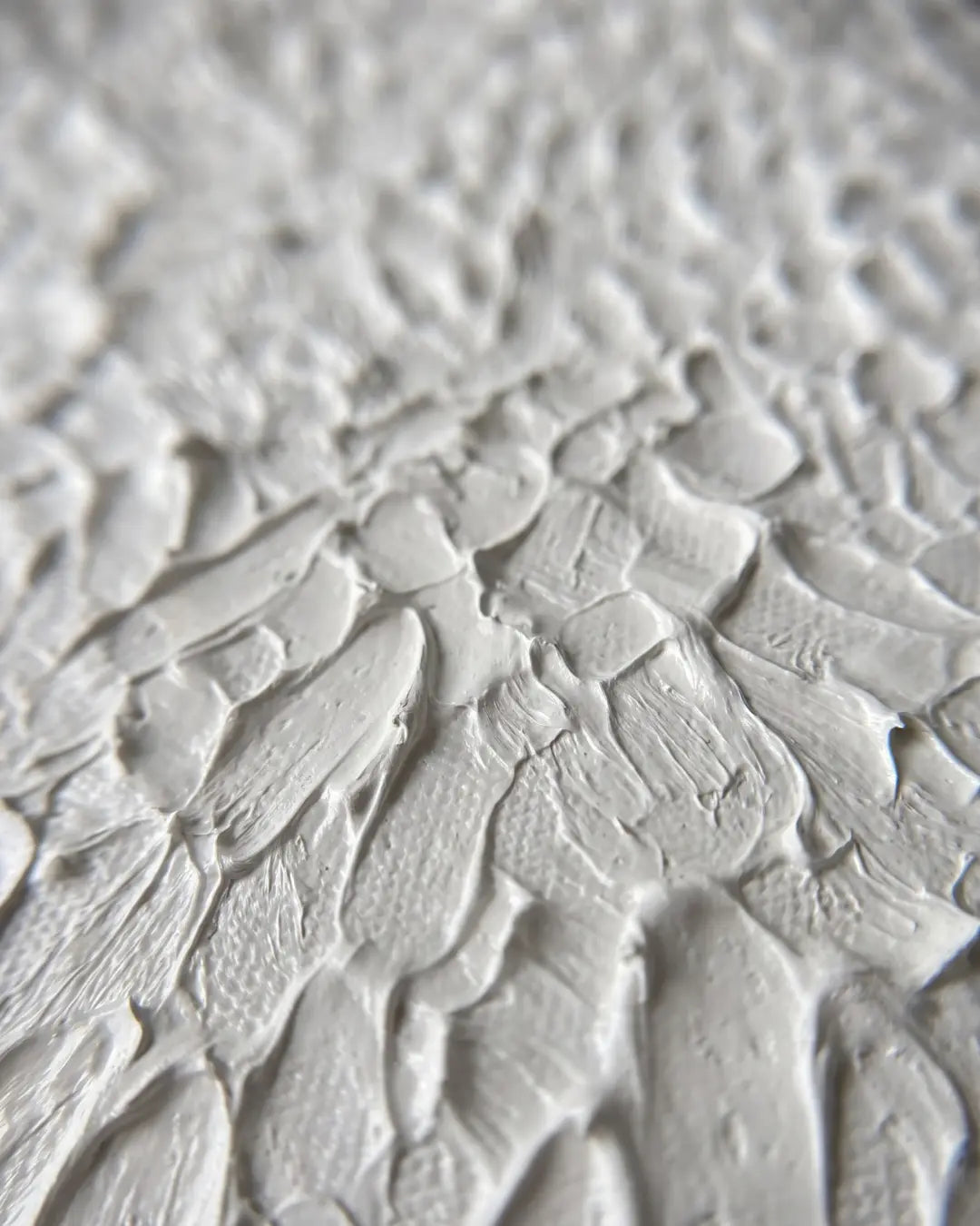 Close-up of The White Relief canvas showing dense hand-carved crackled plaster texture