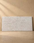Ivory textured wall art with dense hand-carved crackled relief on plain background, handmade canvas painting