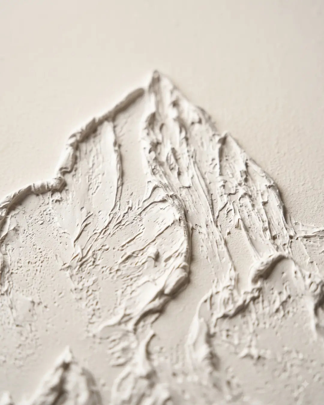 Close-up of raised white plaster on White Peak canvas showing hand-sculpted mountain ridges